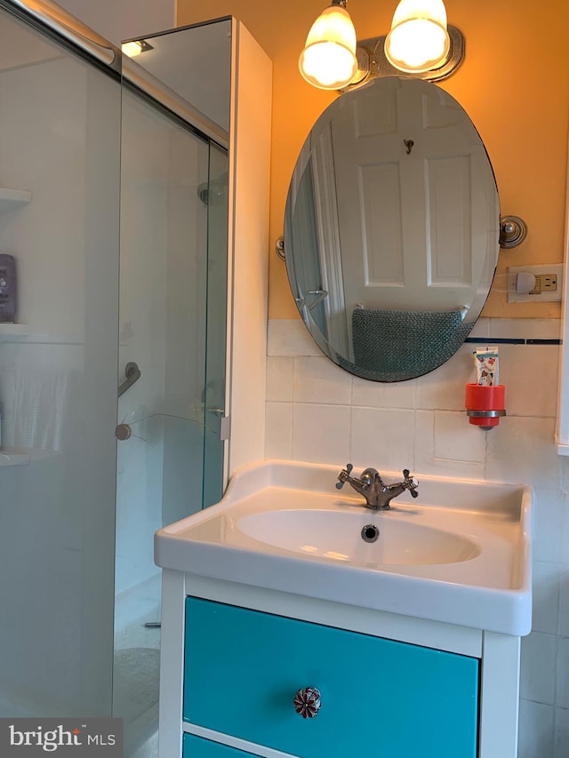 2619 Filbert Ave, Reading, PA 19606 - bathroom featuring a shower stall, vanity, and decorative backsplash