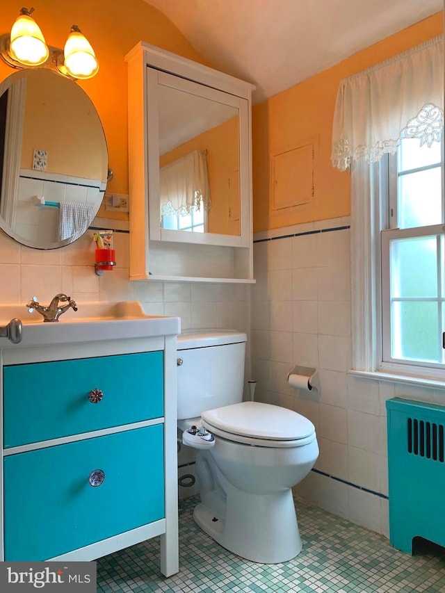 2619 Filbert Ave, Reading, PA 19606 - half bathroom featuring radiator heating unit, vanity, tile walls, toilet, and tile patterned flooring