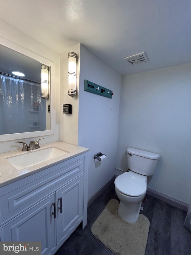 2619 Filbert Ave, Reading, PA 19606 - bathroom featuring toilet, wood finished floors, vanity, and curtained shower