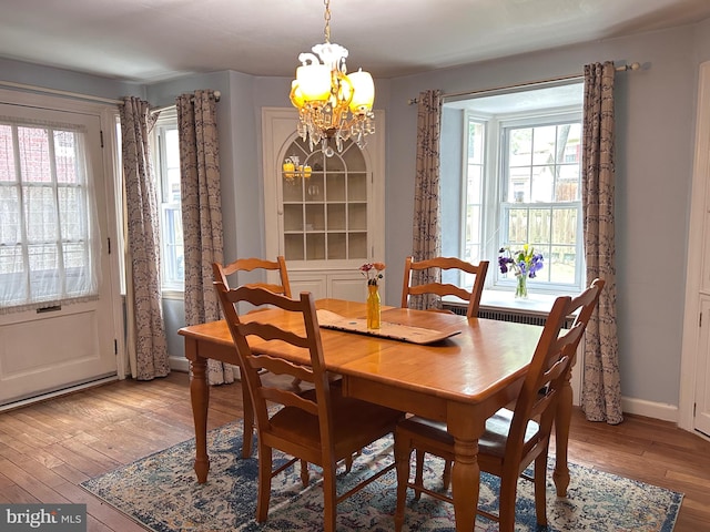 2619 Filbert Ave, Reading, PA 19606 - dining area with a chandelier, light wood-style floors, and baseboards