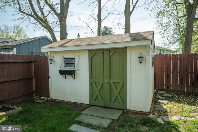 view of shed with a fenced backyard