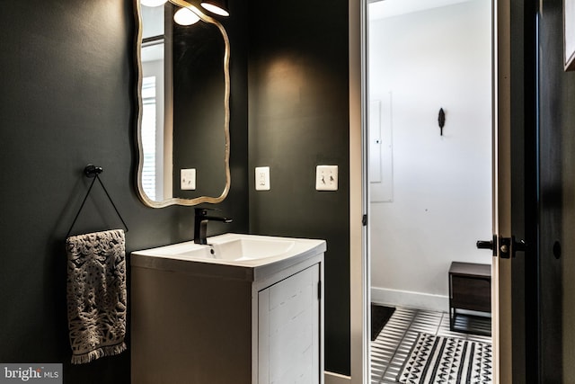 bathroom featuring tile patterned floors, baseboards, and vanity