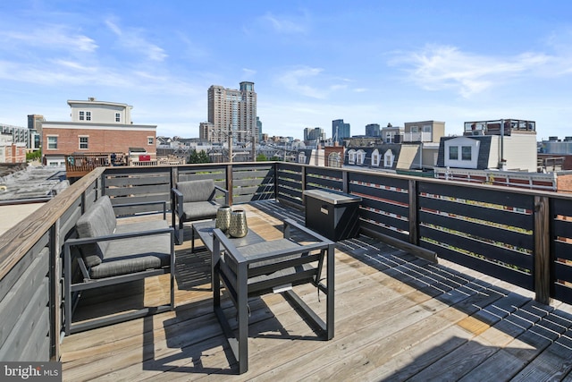 deck featuring outdoor lounge area and a view of city