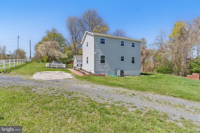 671 Pine Ridge Dr, Front Royal, VA 22630 - view of side of home featuring a lawn, central AC unit, and fence
