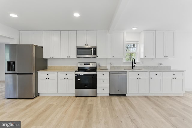 671 Pine Ridge Dr, Front Royal, VA 22630 - kitchen with light wood-type flooring, recessed lighting, white cabinets, a sink, and stainless steel appliances