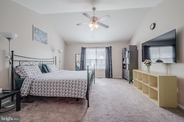 carpeted bedroom featuring vaulted ceiling, baseboards, and ceiling fan