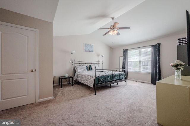 carpeted bedroom featuring lofted ceiling, a ceiling fan, and baseboards