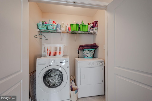 washroom with washer and clothes dryer, laundry area, and light tile patterned floors