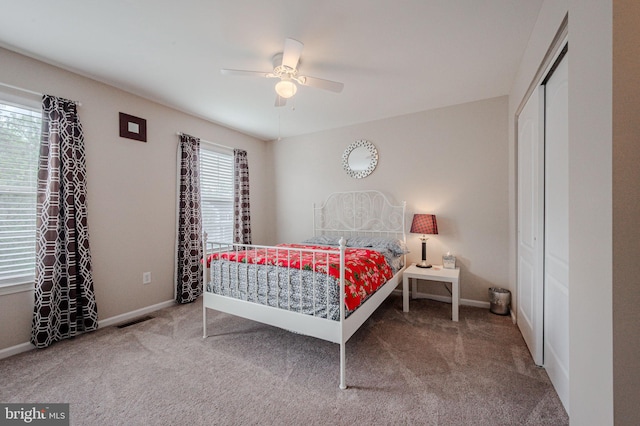 bedroom featuring visible vents, carpet floors, a closet, baseboards, and ceiling fan