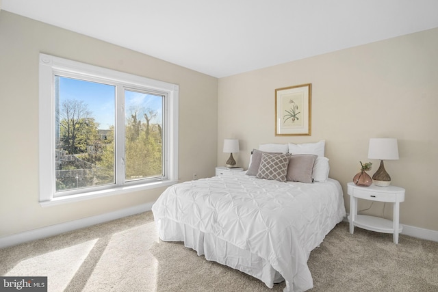 carpeted bedroom with baseboards