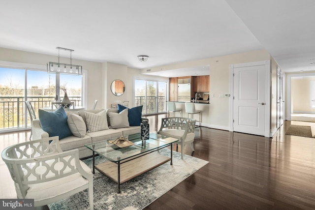 living room with baseboards and dark wood-style floors