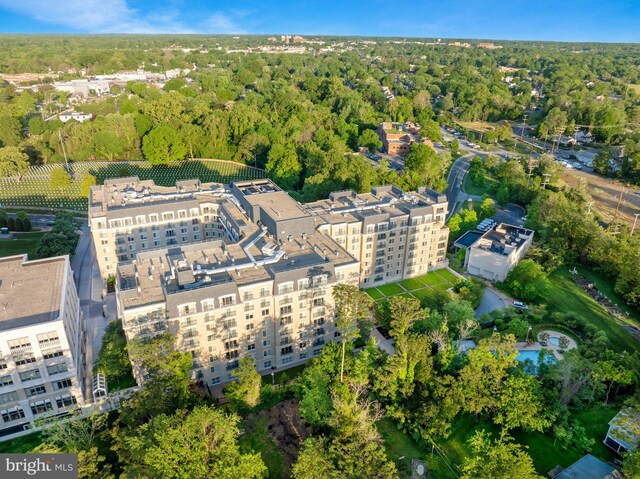 drone / aerial view featuring a wooded view