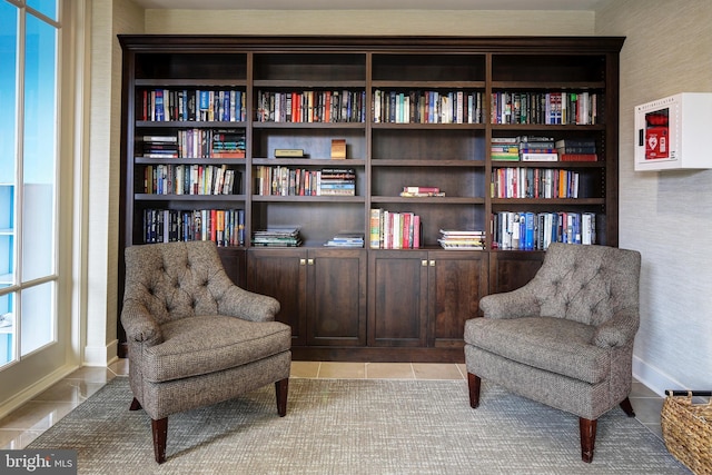 living area featuring baseboards and tile patterned floors