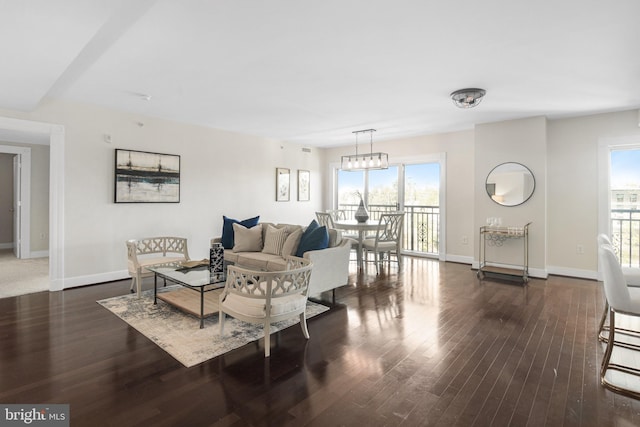 living area featuring wood finished floors, a healthy amount of sunlight, and baseboards