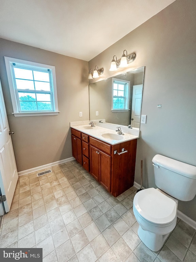 257 Morlatt Ln, Martinsburg, WV 25404 - bathroom featuring healthy amount of natural light, toilet, baseboards, and double vanity