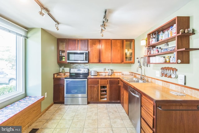 9427 Candleberry Ct, Burke, VA 22015 - kitchen featuring appliances with stainless steel finishes, rail lighting, a healthy amount of sunlight, and a sink