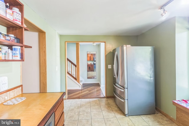 9427 Candleberry Ct, Burke, VA 22015 - kitchen featuring light tile patterned floors, rail lighting, open shelves, baseboards, and freestanding refrigerator