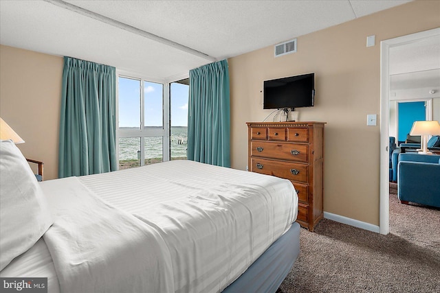 carpeted bedroom featuring visible vents and baseboards