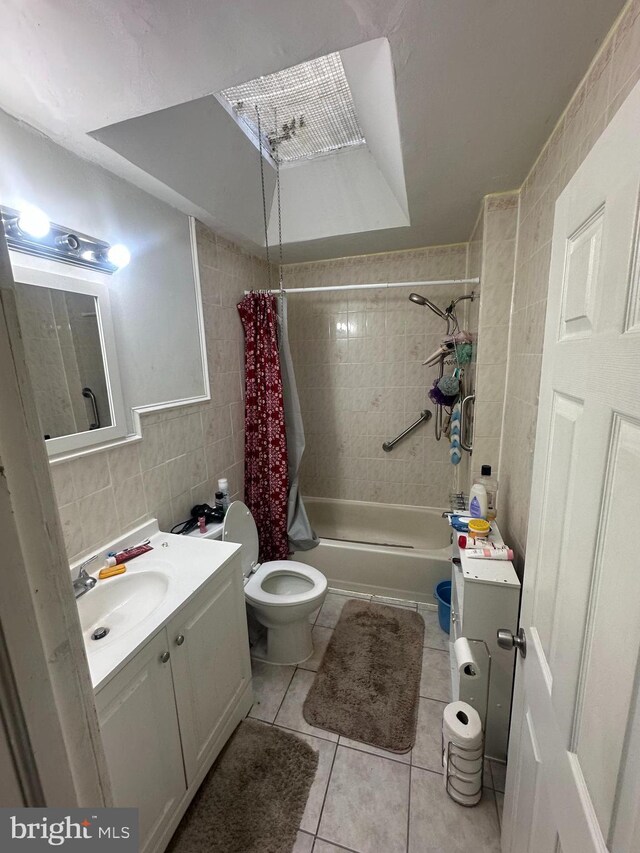full bathroom with shower / bath combo, vanity, toilet, tile patterned floors, and tile walls