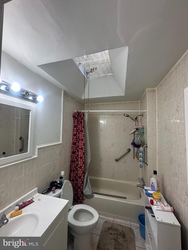 bathroom featuring vanity, tile walls, shower / bath combo, and tile patterned floors