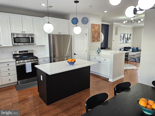 1317 Lowman St, Baltimore, MD 21230 - kitchen with stainless steel appliances, light countertops, ornamental molding, and recessed lighting