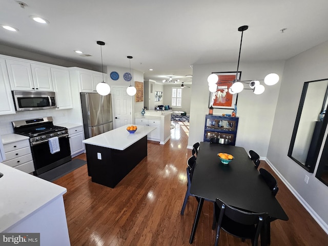 1317 Lowman St, Baltimore, MD 21230 - kitchen with dark wood-style floors, light countertops, appliances with stainless steel finishes, and a kitchen island