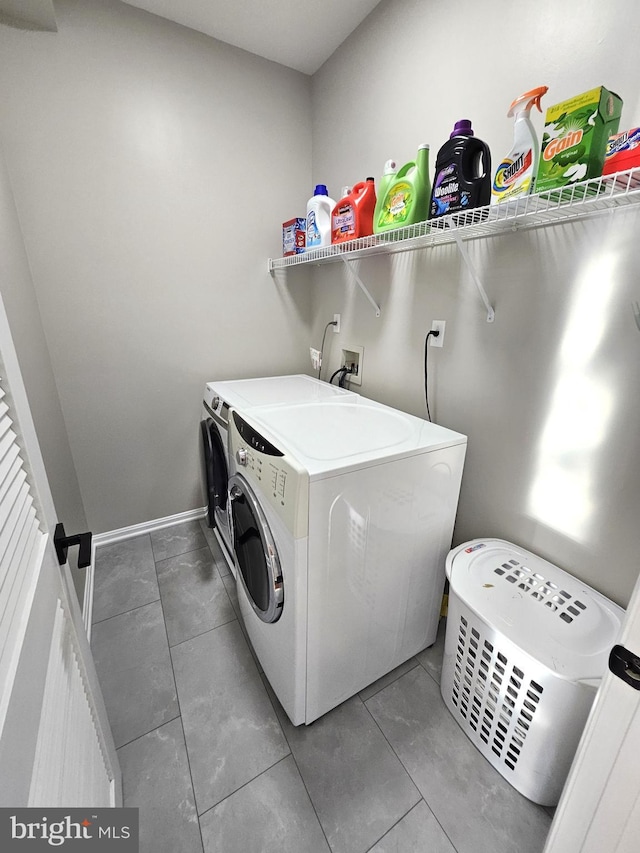 1317 Lowman St, Baltimore, MD 21230 - washroom featuring baseboards, tile patterned flooring, laundry area, and washing machine and dryer