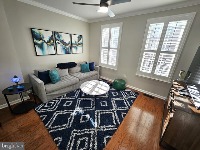 1317 Lowman St, Baltimore, MD 21230 - living area with crown molding, visible vents, wood finished floors, and baseboards