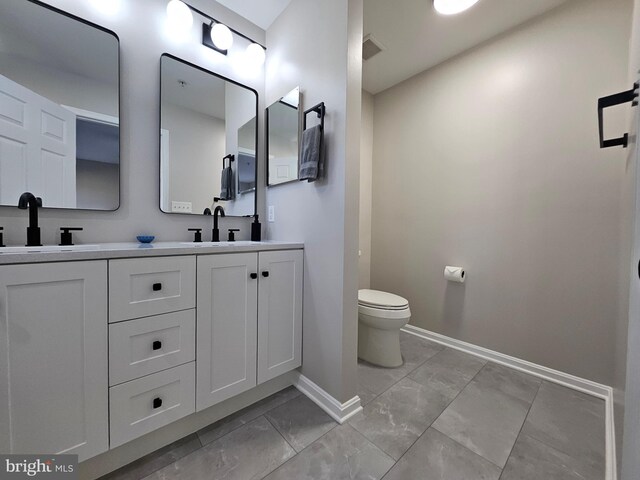 1317 Lowman St, Baltimore, MD 21230 - bathroom featuring toilet, baseboards, marble finish floor, and a sink
