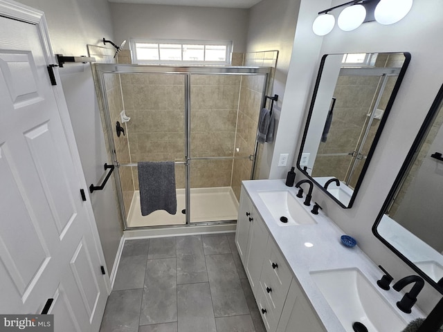 1317 Lowman St, Baltimore, MD 21230 - bathroom featuring double vanity, a sink, a shower stall, and tile patterned floors