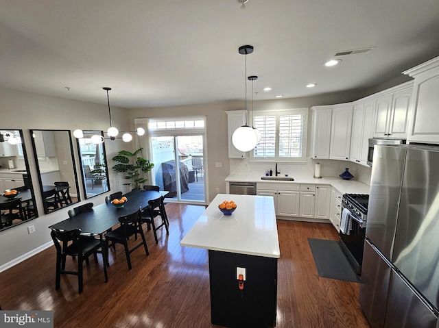 1317 Lowman St, Baltimore, MD 21230 - kitchen featuring a sink, dark wood-style flooring, stainless steel appliances, and light countertops