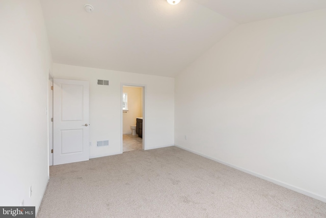 2685 Victorian Dr Lot 67, Dover, PA 17315 - unfurnished bedroom with lofted ceiling, visible vents, light carpet, and connected bathroom