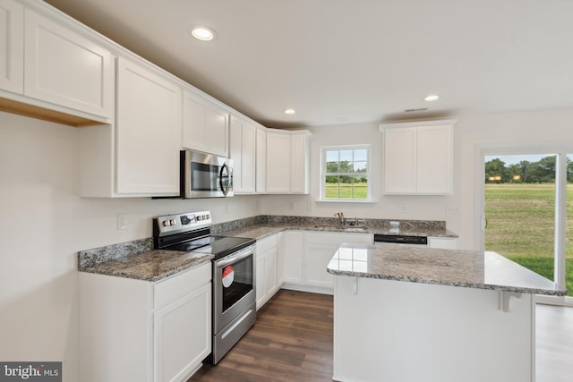 2685 Victorian Dr Lot 67, Dover, PA 17315 - kitchen with dark wood finished floors, white cabinets, light stone countertops, and stainless steel appliances