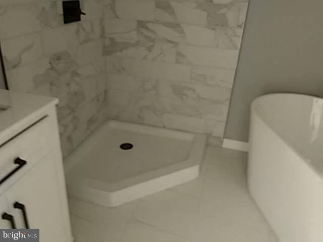 full bathroom featuring vanity and a stall shower