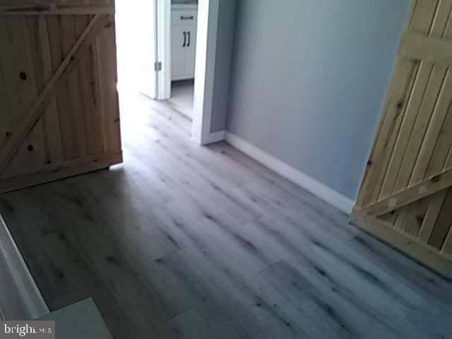 interior space with baseboards and wood finished floors