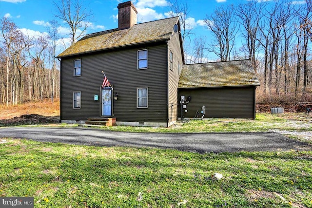 exterior space with a lawn and a chimney