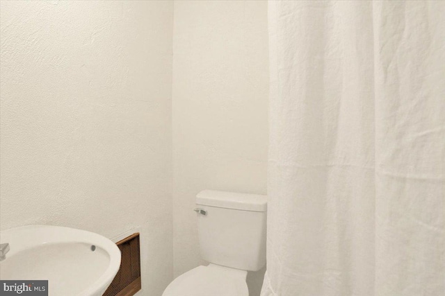 bathroom with visible vents and toilet