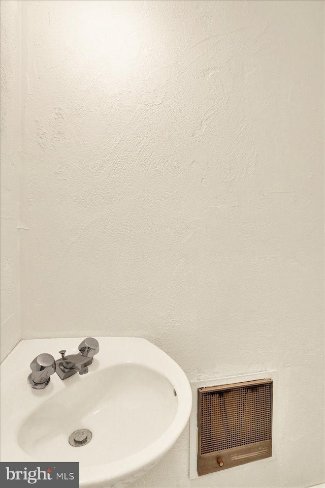 bathroom with visible vents and a sink