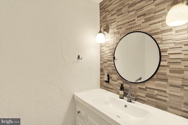 bathroom featuring tasteful backsplash, tile walls, and vanity