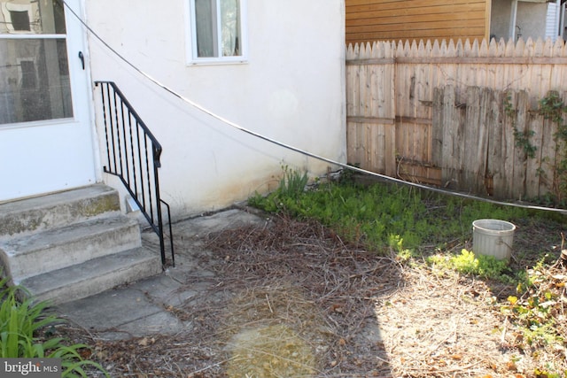 exterior space with fence and stucco siding