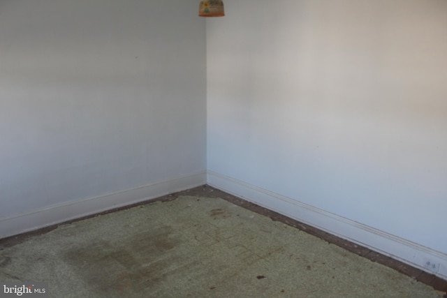 spare room with baseboards