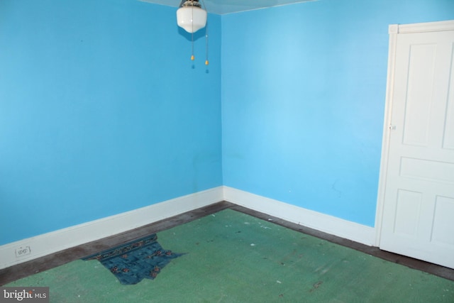 unfurnished room with baseboards
