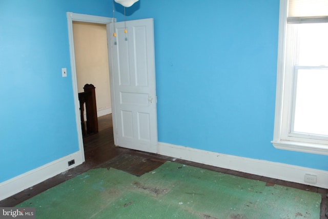 spare room with baseboards and a wealth of natural light