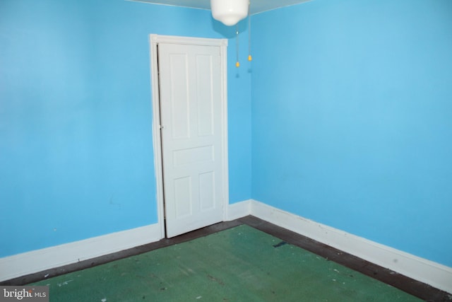 spare room with baseboards