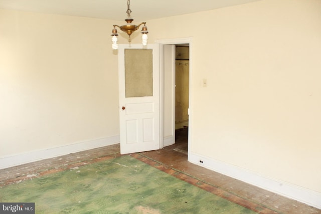 empty room featuring baseboards