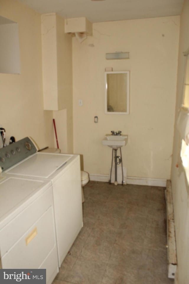 laundry area featuring washer and dryer, laundry area, and light floors