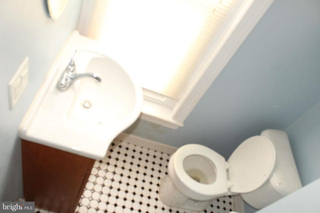bathroom with tile patterned flooring, a sink, and toilet