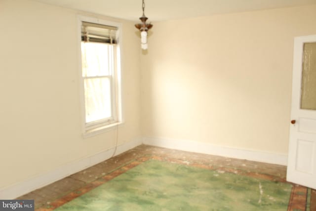 unfurnished room featuring baseboards