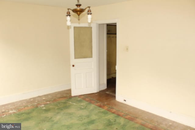 unfurnished room featuring baseboards