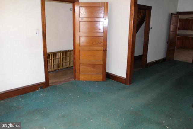 unfurnished bedroom with carpet flooring and baseboards